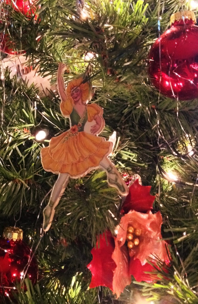 Vintage Christmas ornaments & poinsettias adorn the tree.